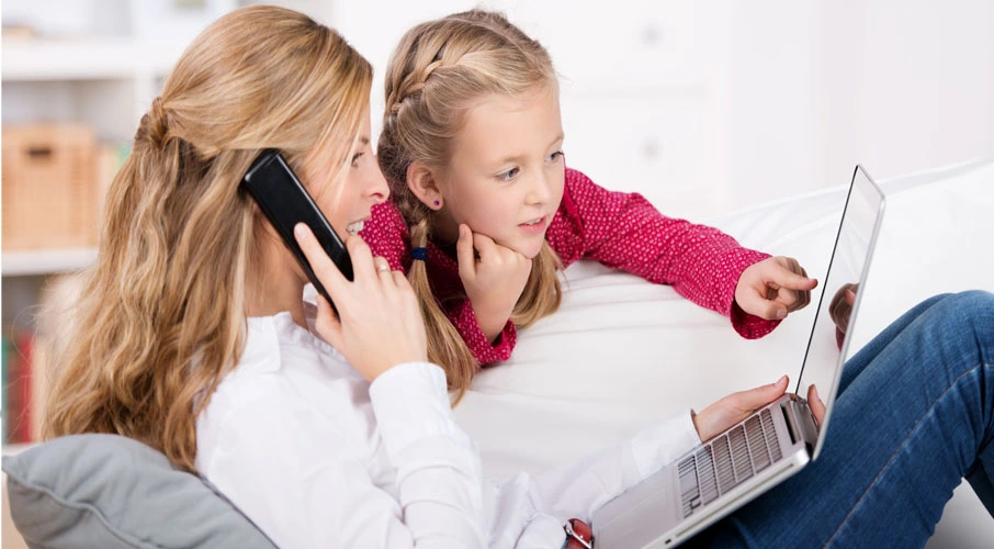 Mother and daughter using dsl internet on computer