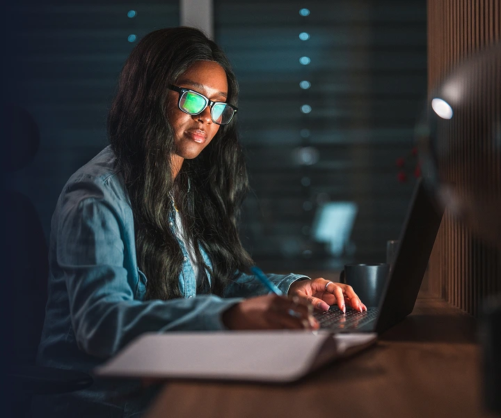 A young woman working on a laptop