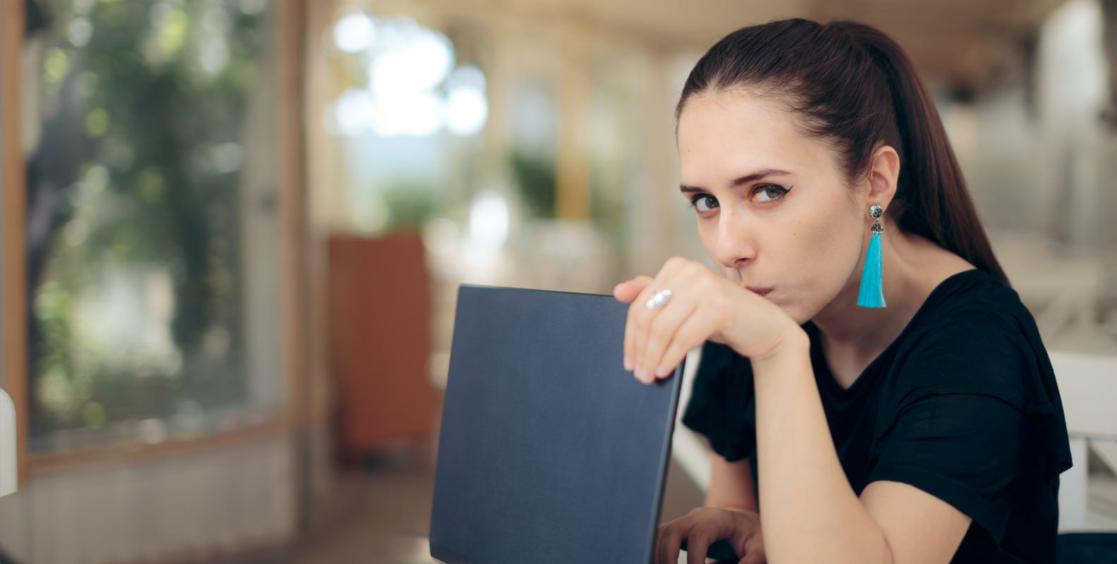 Woman protecting password privacy on laptop