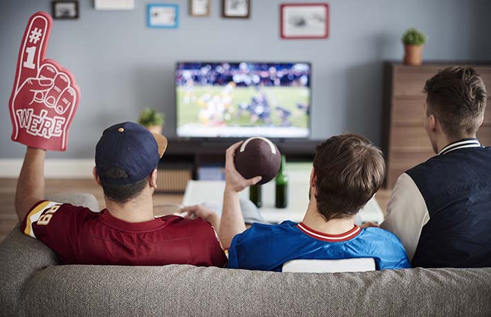 Men watching Sunday Night Football in living room