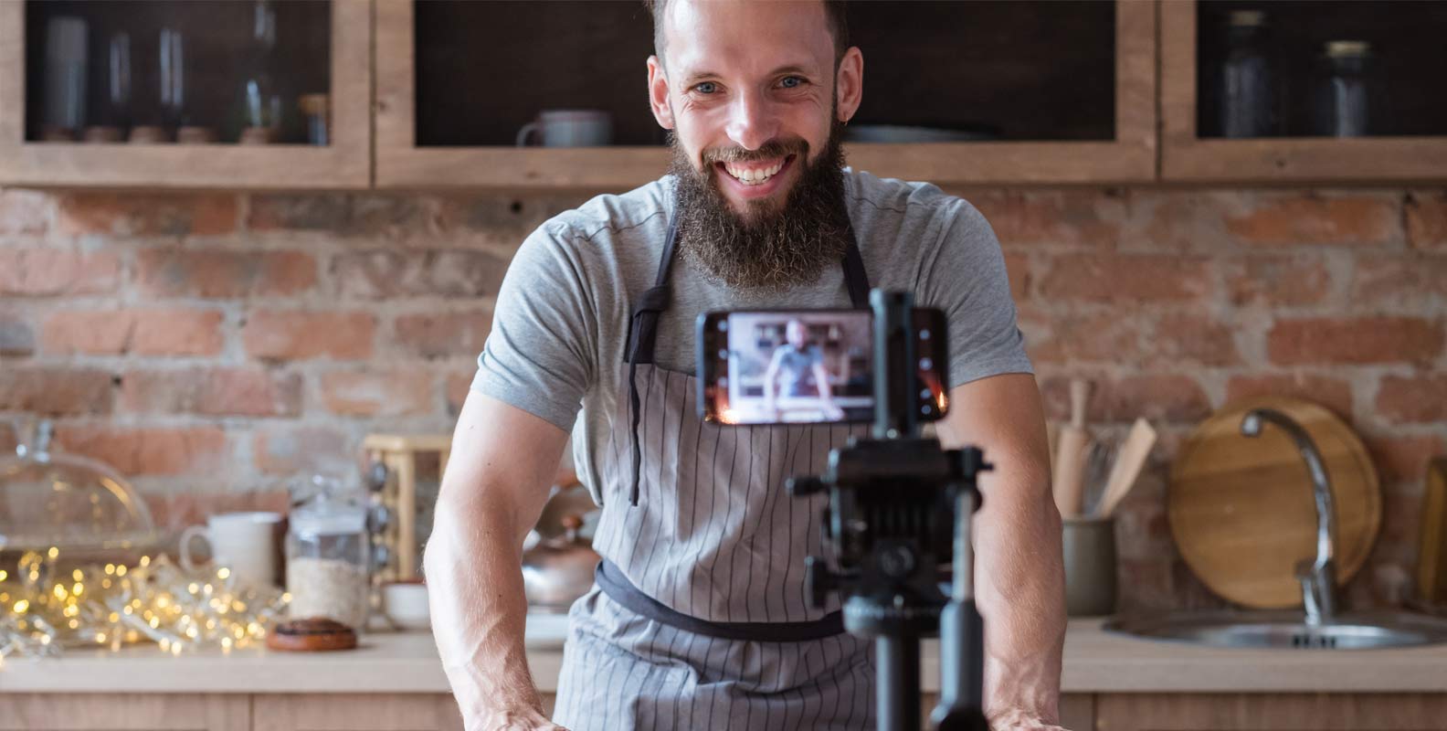 Man using phone to live stream in kitchen